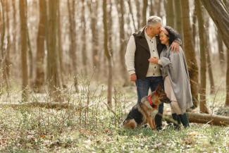 retired couple with their dog in nature grateful for their retirememt specialists