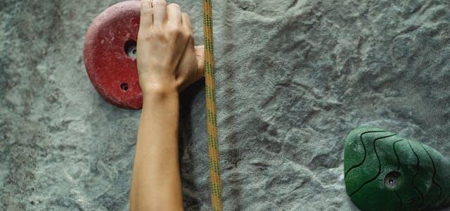 Risk in the retirement red zone illustrated by person climbing a rock wall