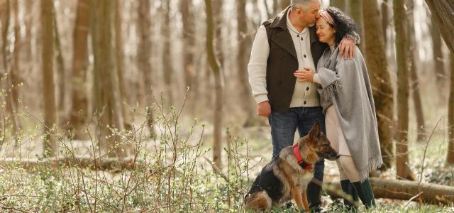 retired couple with their dog in nature grateful for their retirememt specialists